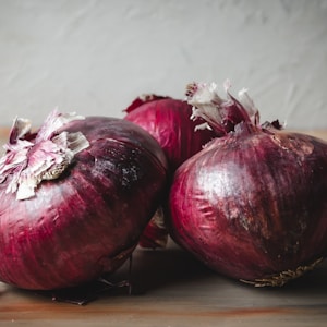 red onion on brown wooden table