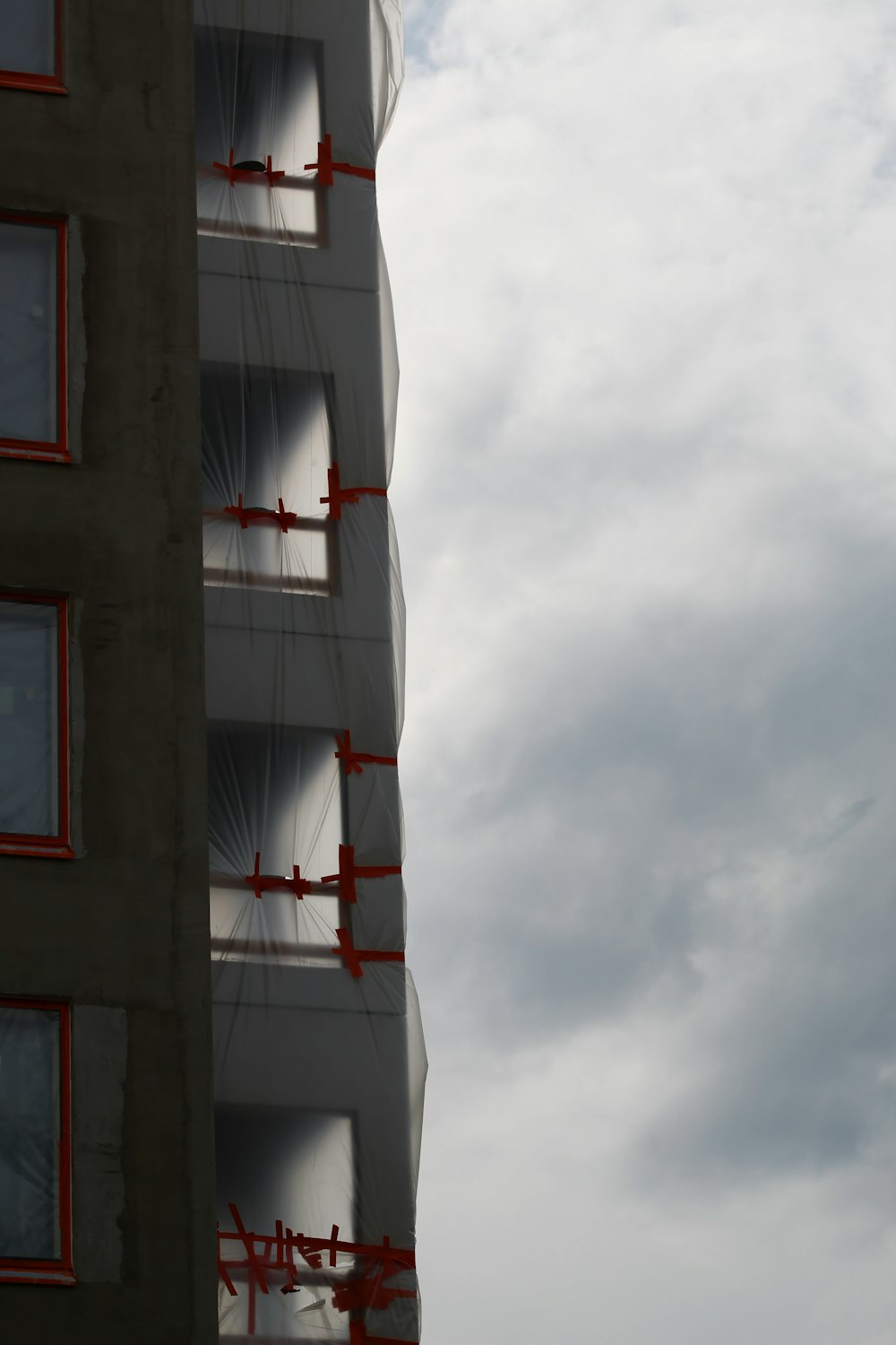 brown and white concrete building under white clouds during daytime