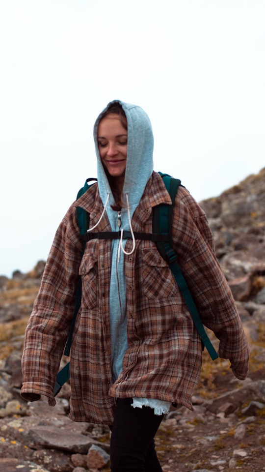 man in blue and red plaid button up shirt and gray hoodie in Mount Aragats Armenia