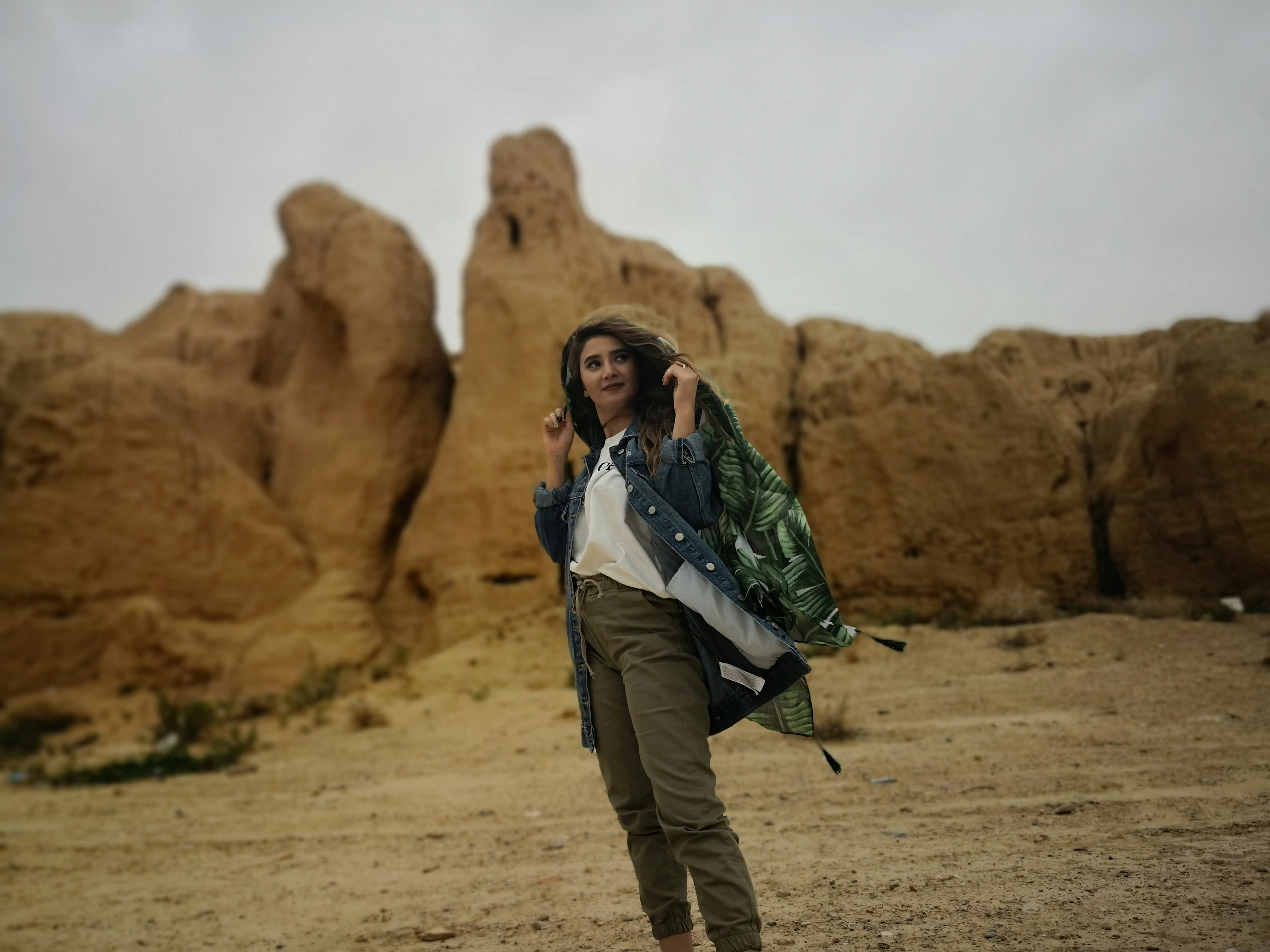 man and woman standing on brown rock formation during daytime iranian teams background