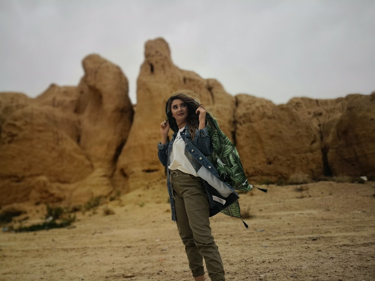 Man and woman standing on brown rock formation during daytime
