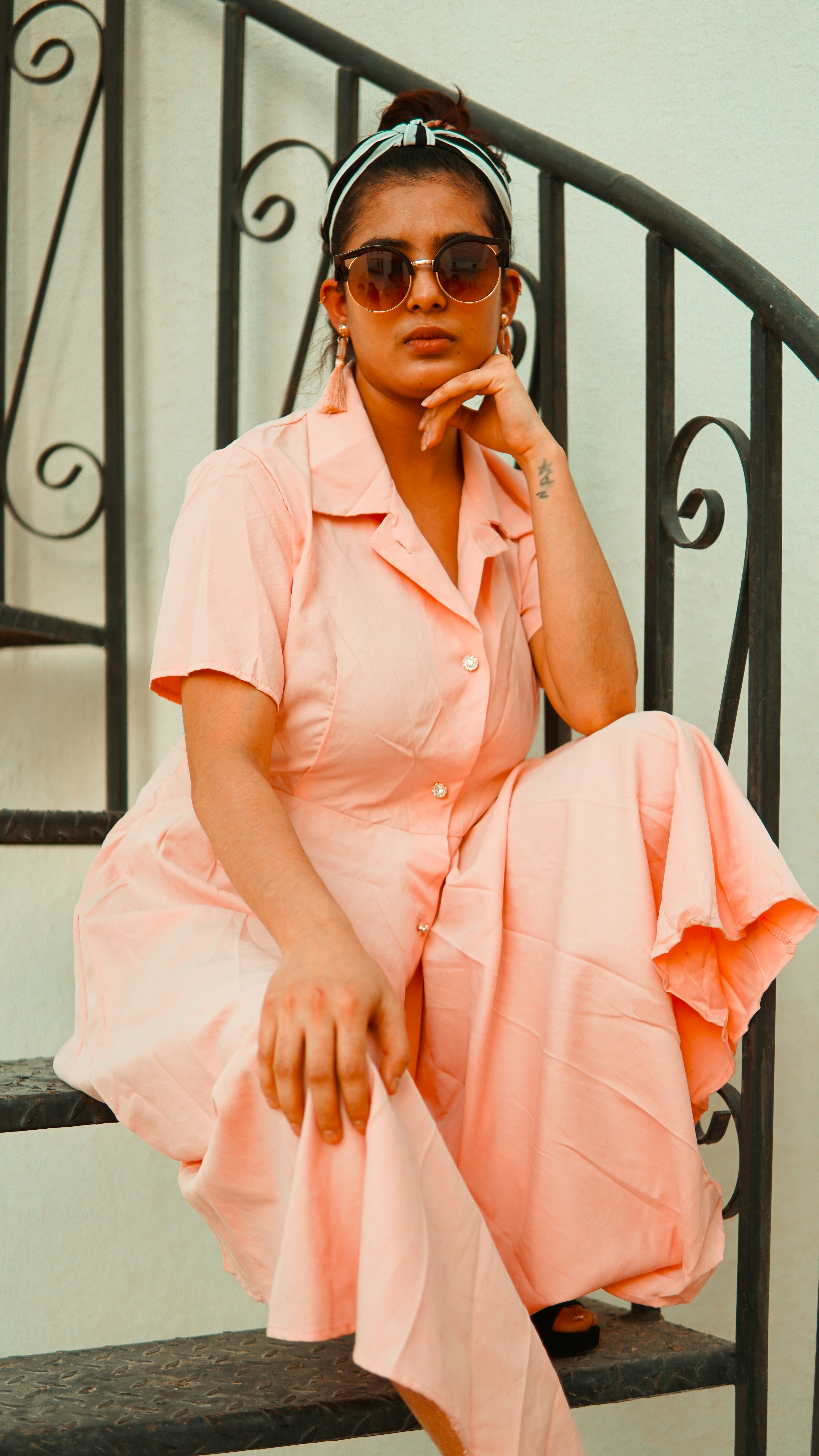 woman in pink button up shirt sitting on black wooden bench
