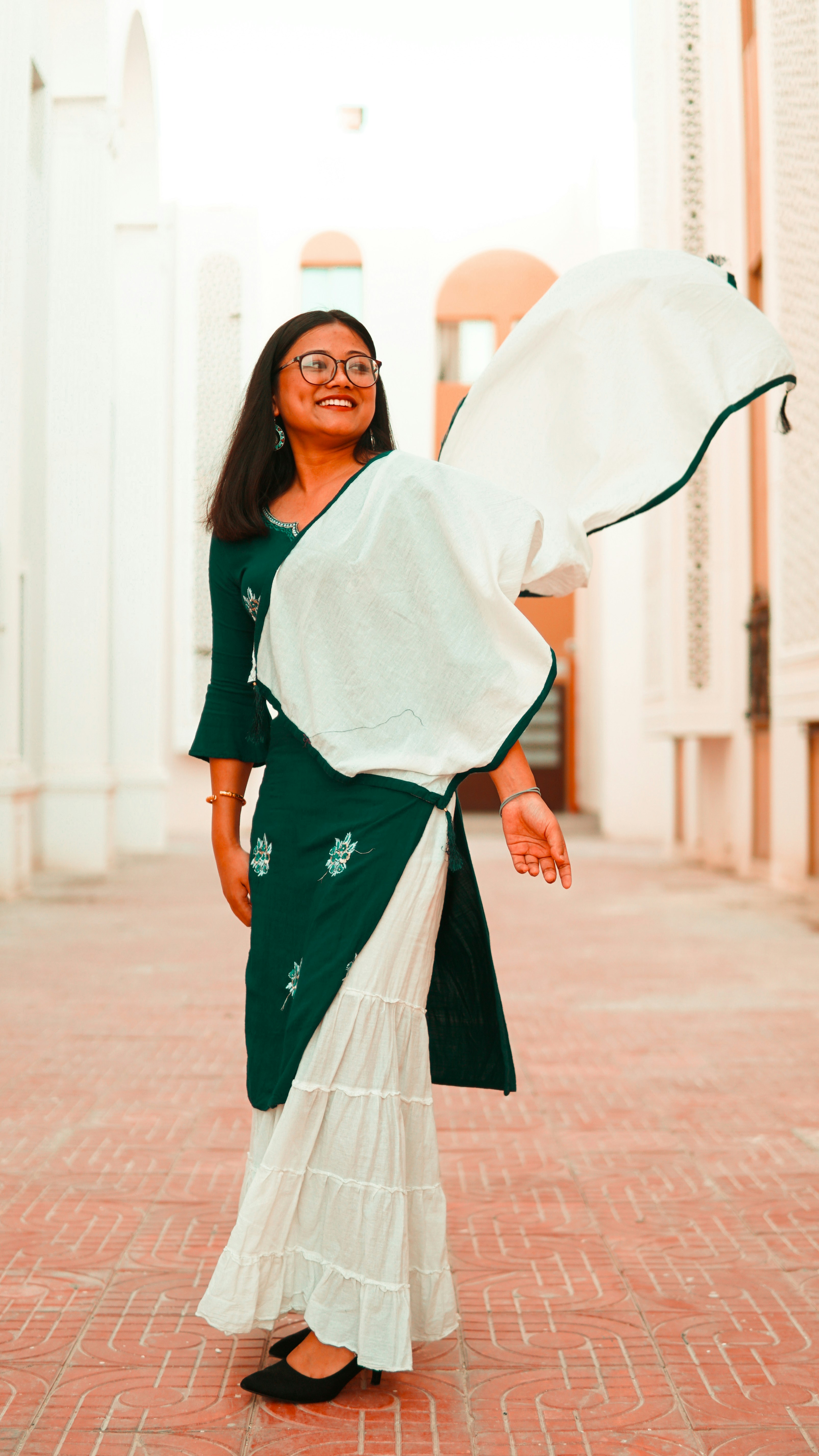 woman in blue and white dress wearing black framed eyeglasses