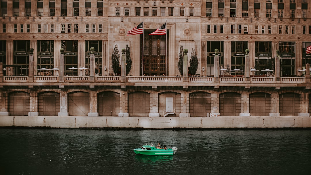 people riding on green boat on river during daytime