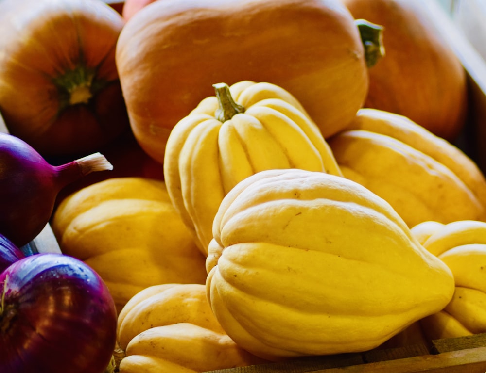 yellow and red squash on brown wooden table