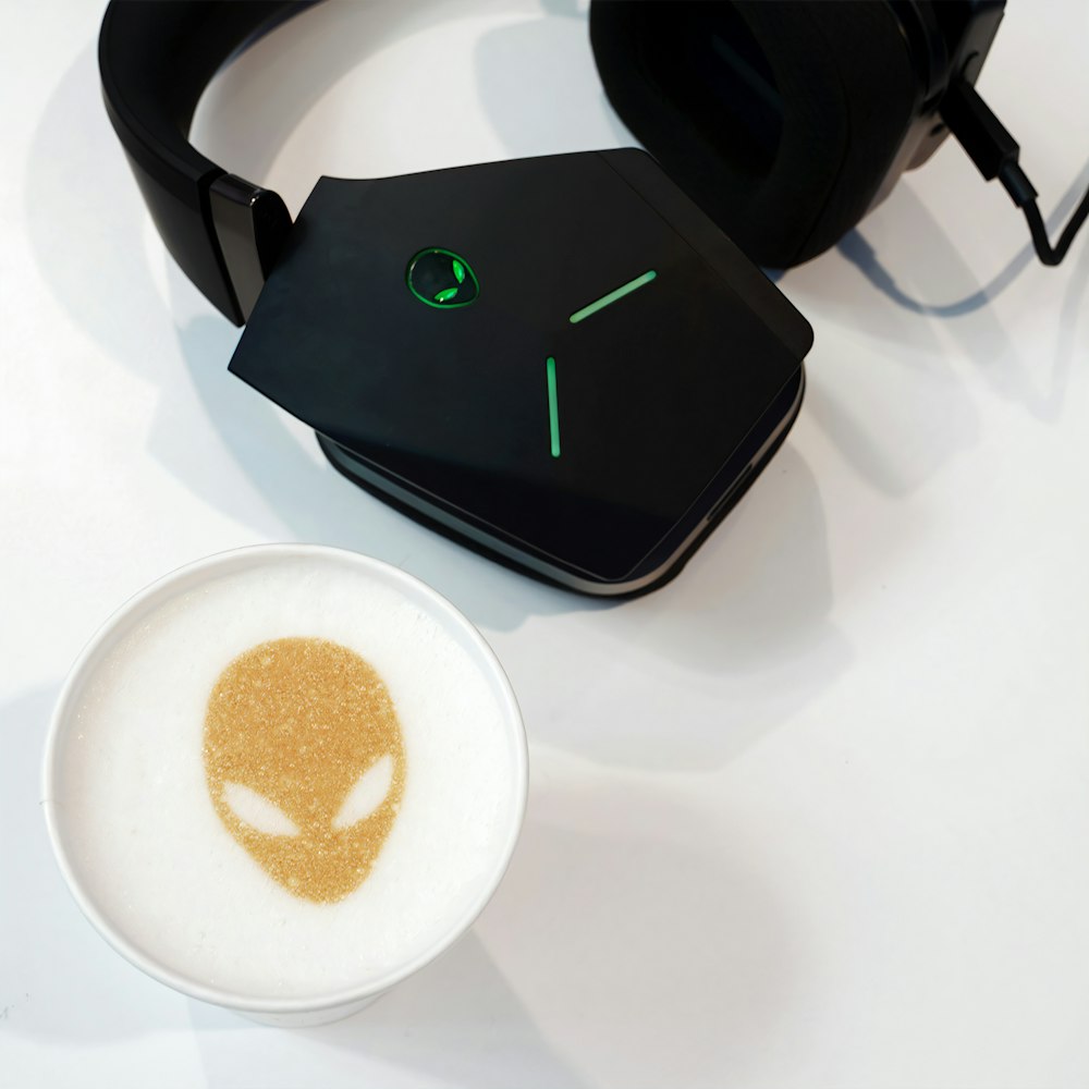 black and white corded headphones on white table