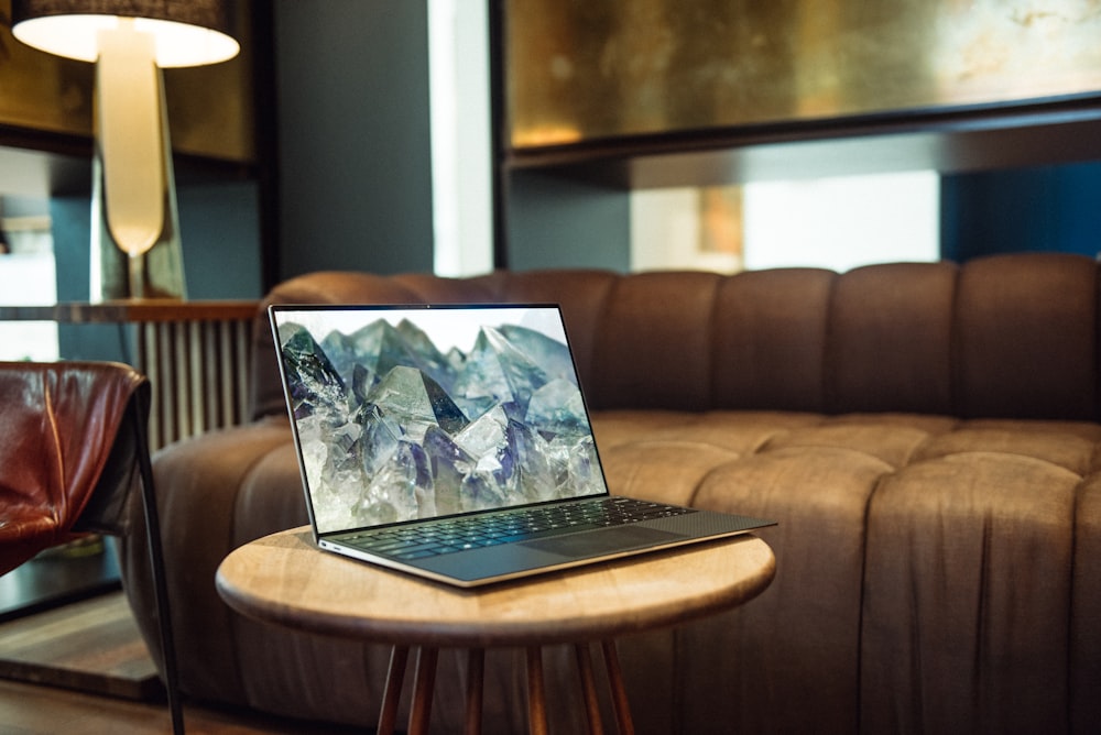 laptop on brown sofa