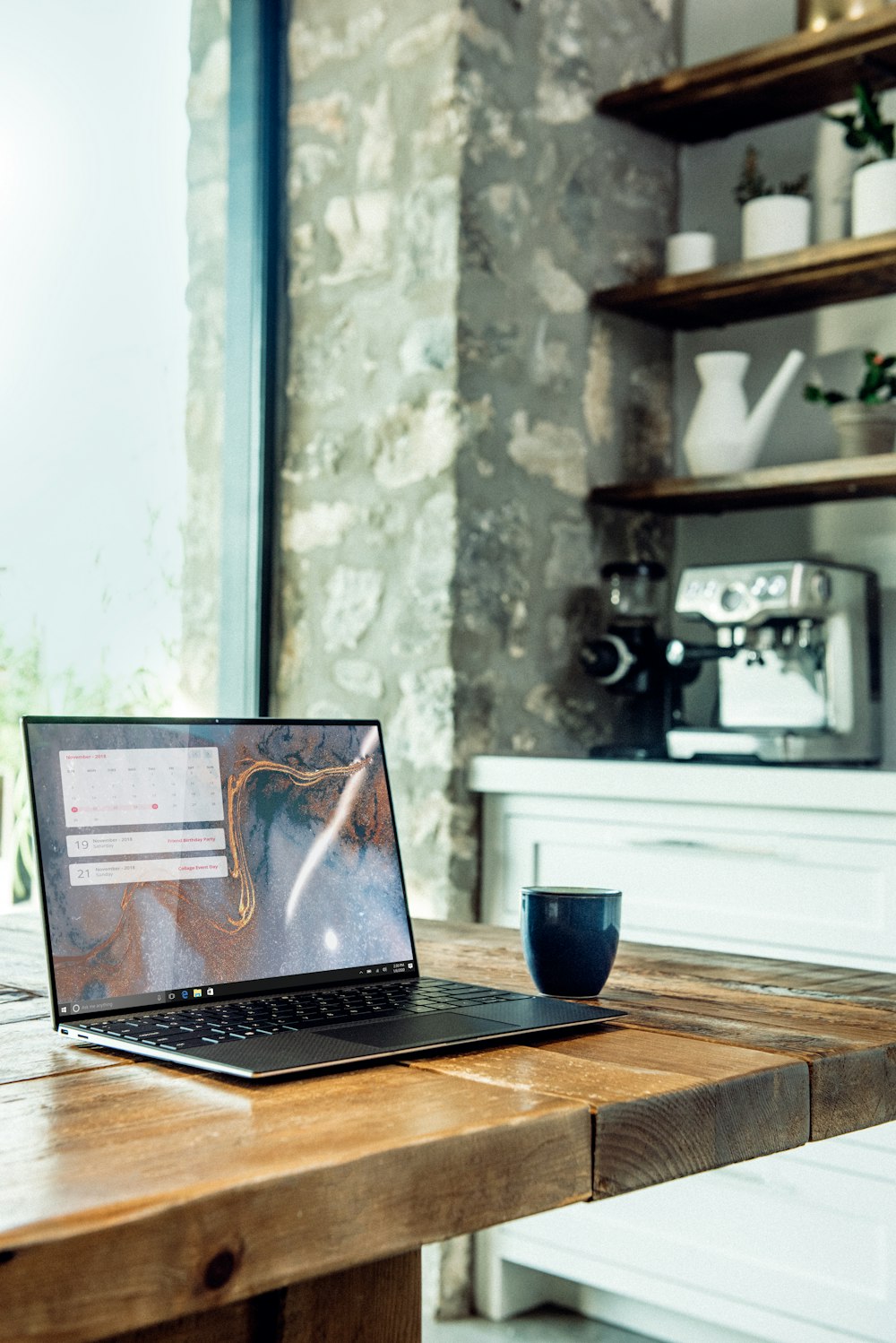 laptop on brown wooden table