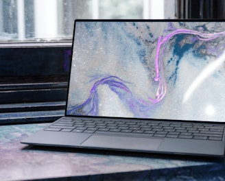 laptop on brown wooden table