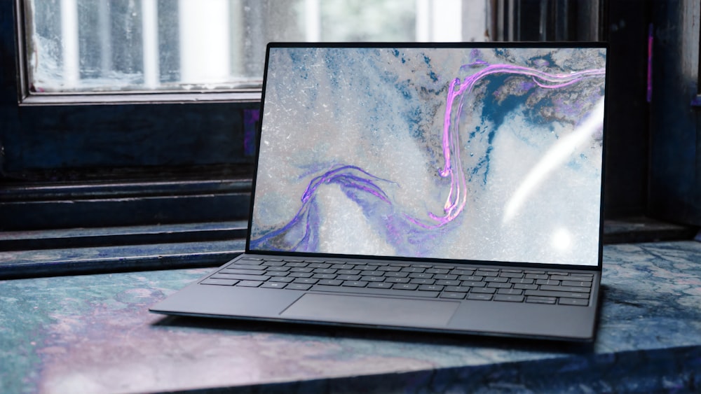 laptop on brown wooden table