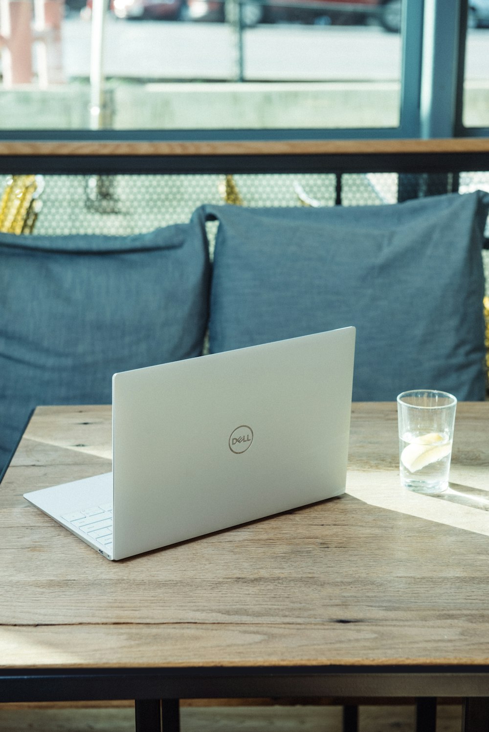 silver laptop on brown wooden table