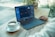person using black laptop computer on brown wooden table