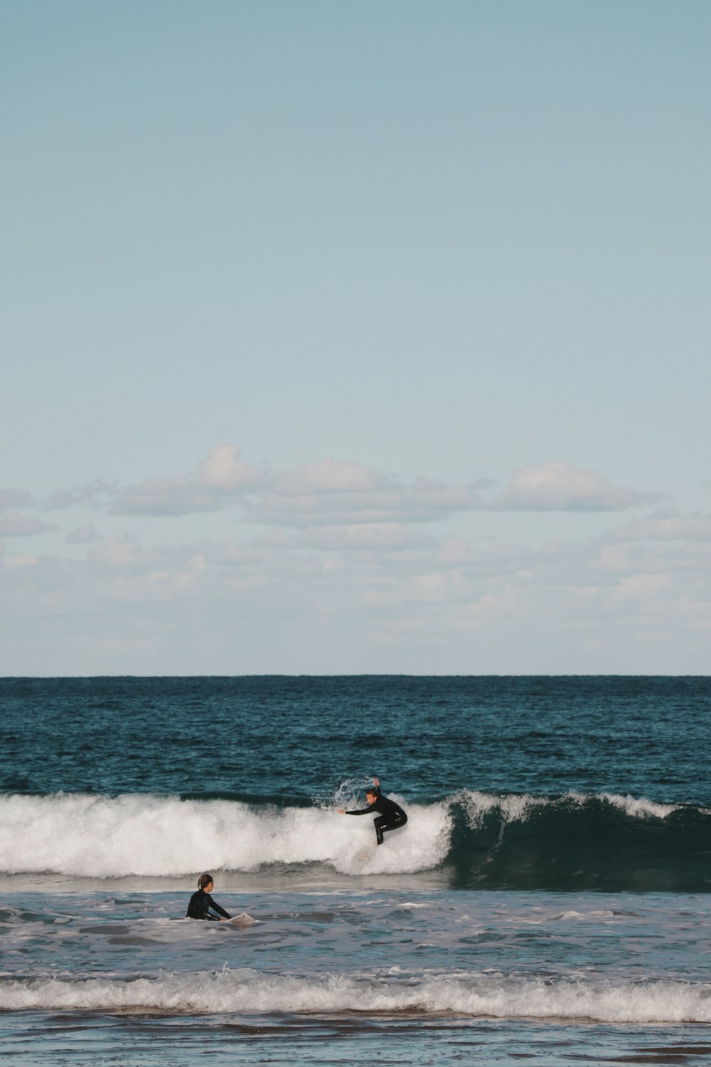 man surfing on sea waves during daytime