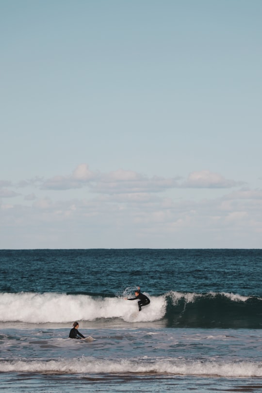 man surfing on sea waves during daytime in Mona Vale Beach Australia
