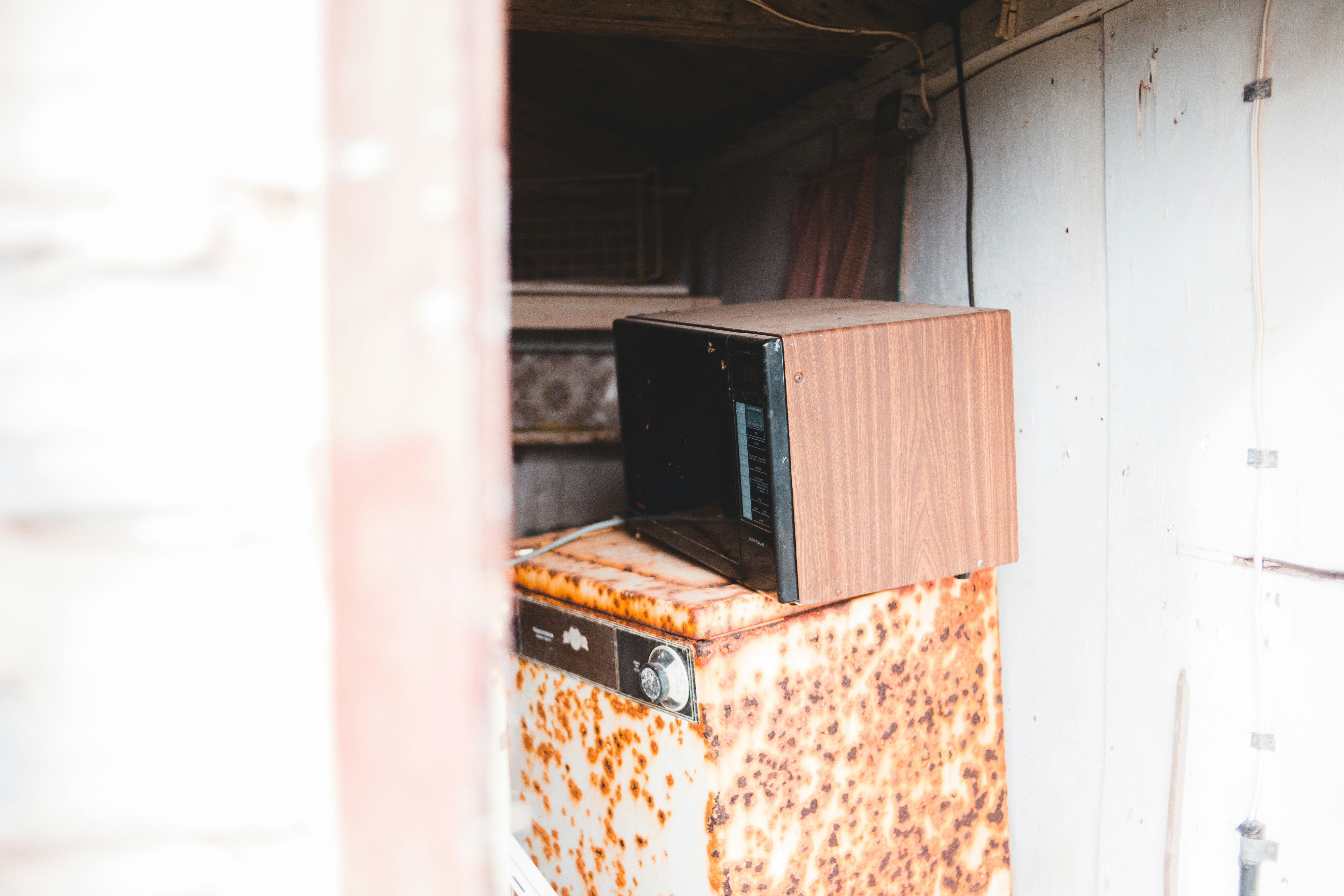 black microwave oven on brown wooden table