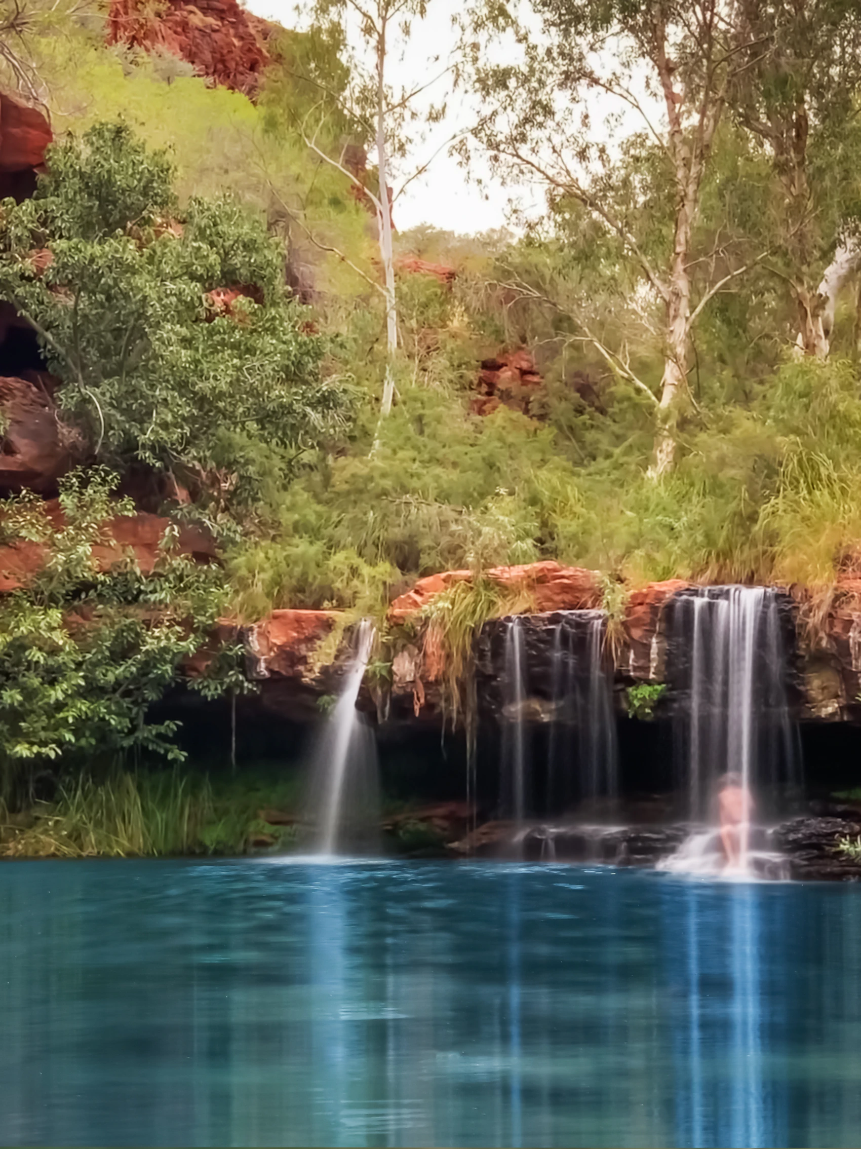 A waterfall descending into a gorge in Karijini National Park