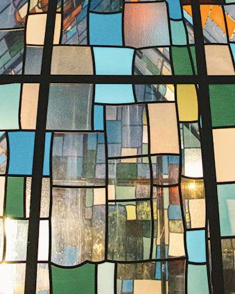 Close-up of a vibrant mosaic tile panel illuminated by soft natural light.