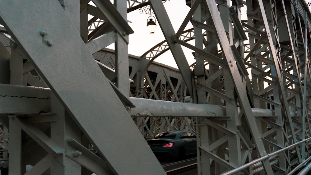 black car on gray metal bridge