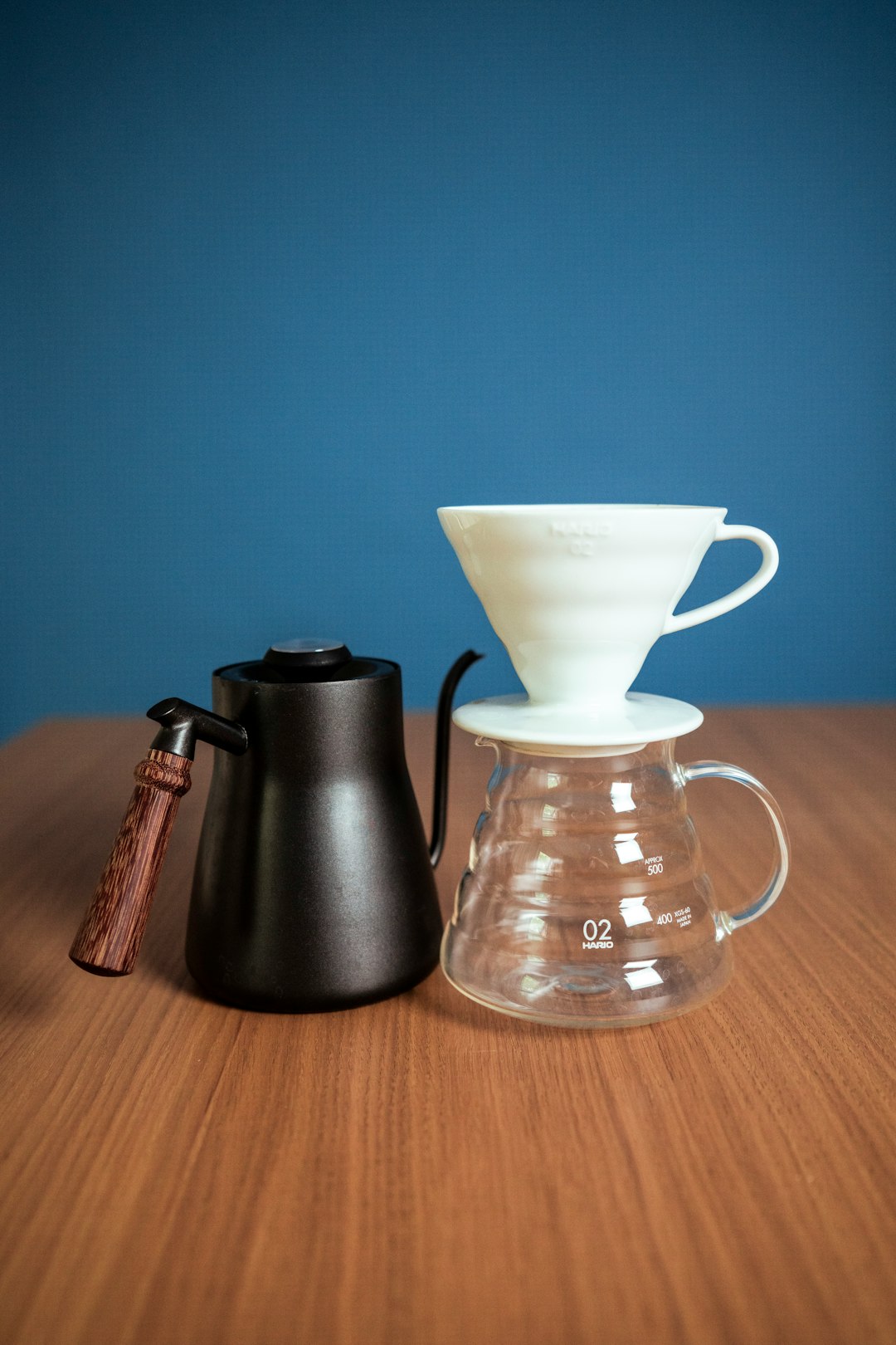 black and silver coffee maker beside white ceramic mug