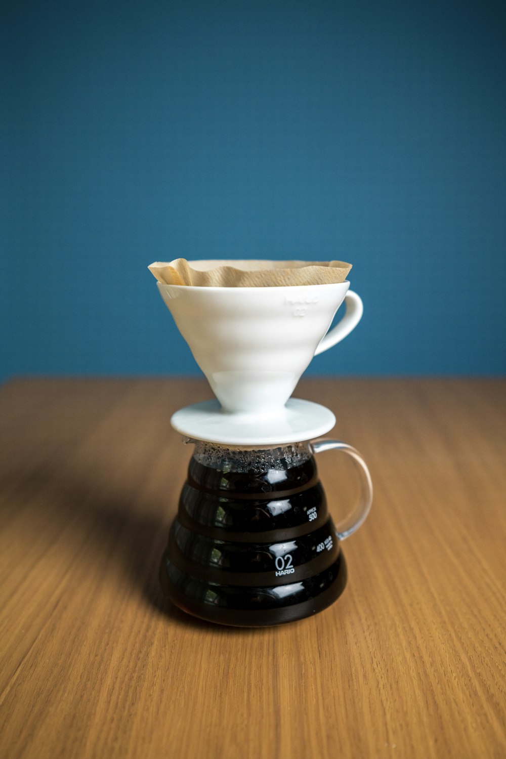 white ceramic teacup on brown wooden table