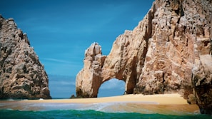brown rock formation on sea during daytime