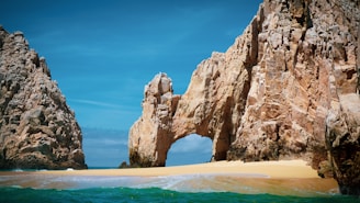 brown rock formation on sea during daytime