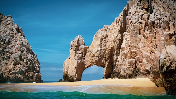 brown rock formation on sea during daytime