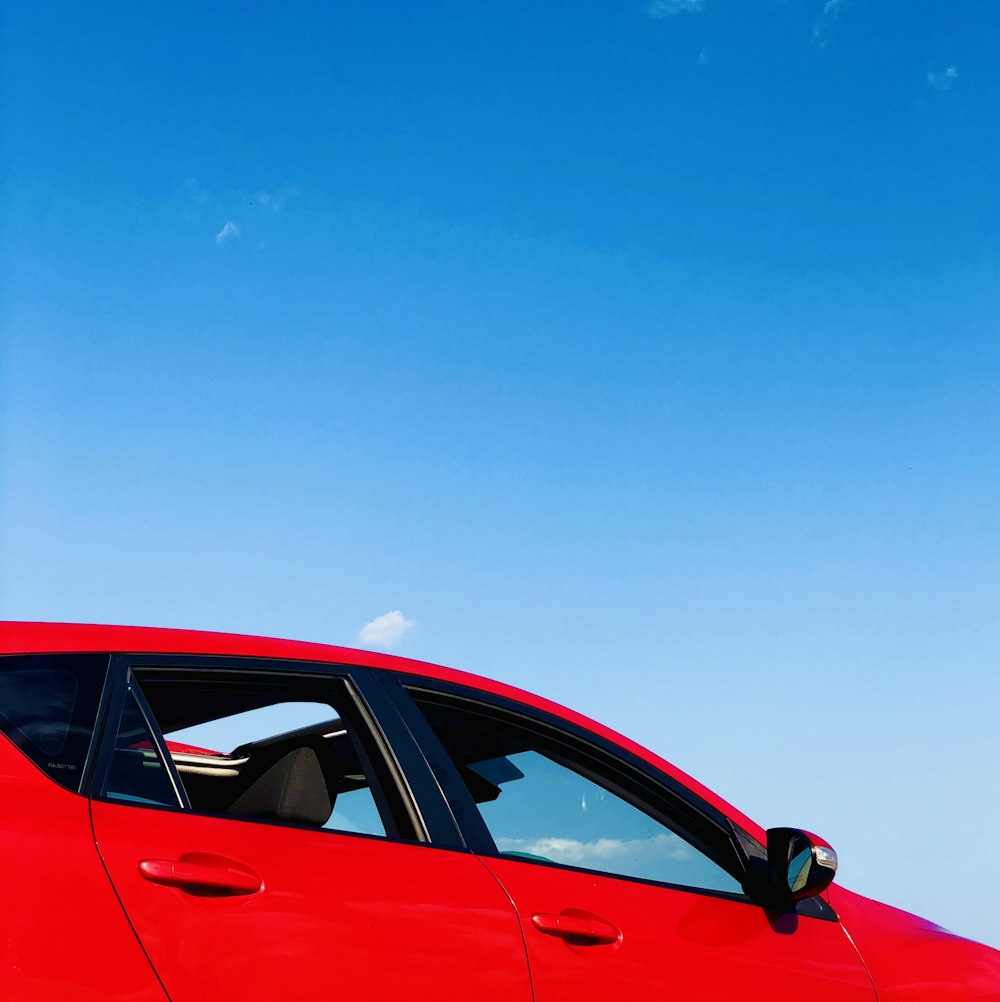 red sedan under blue sky