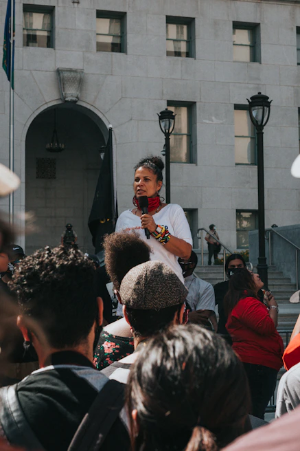 Close-up of a speaker delivering an inspiring message in front of a diverse crowd