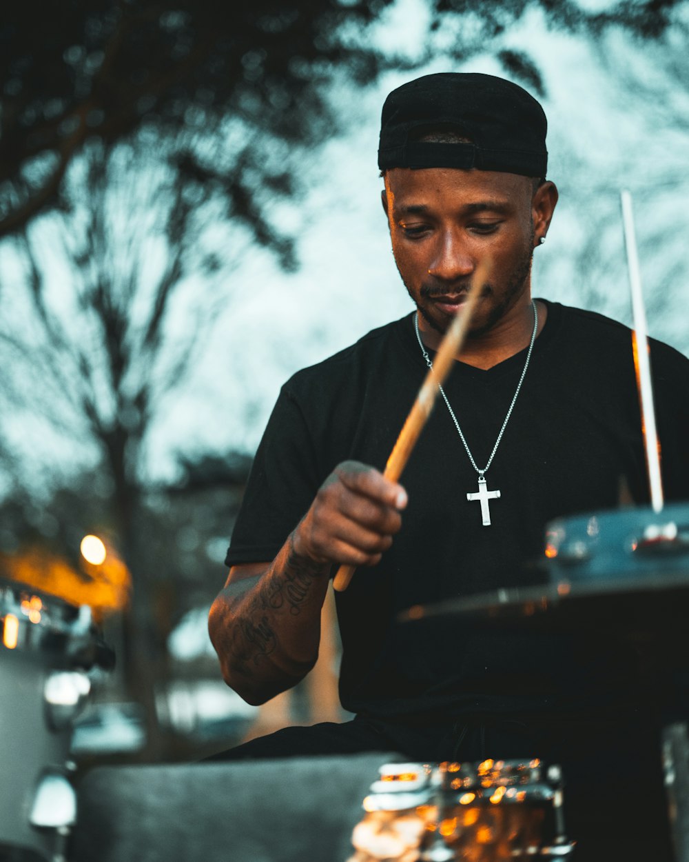 man in black knit cap holding brown stick