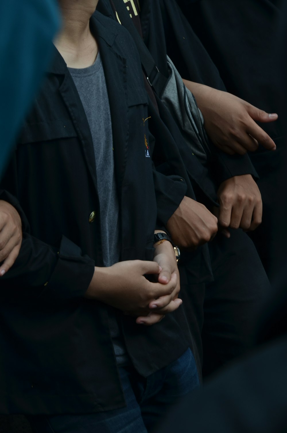 person in black coat wearing silver ring