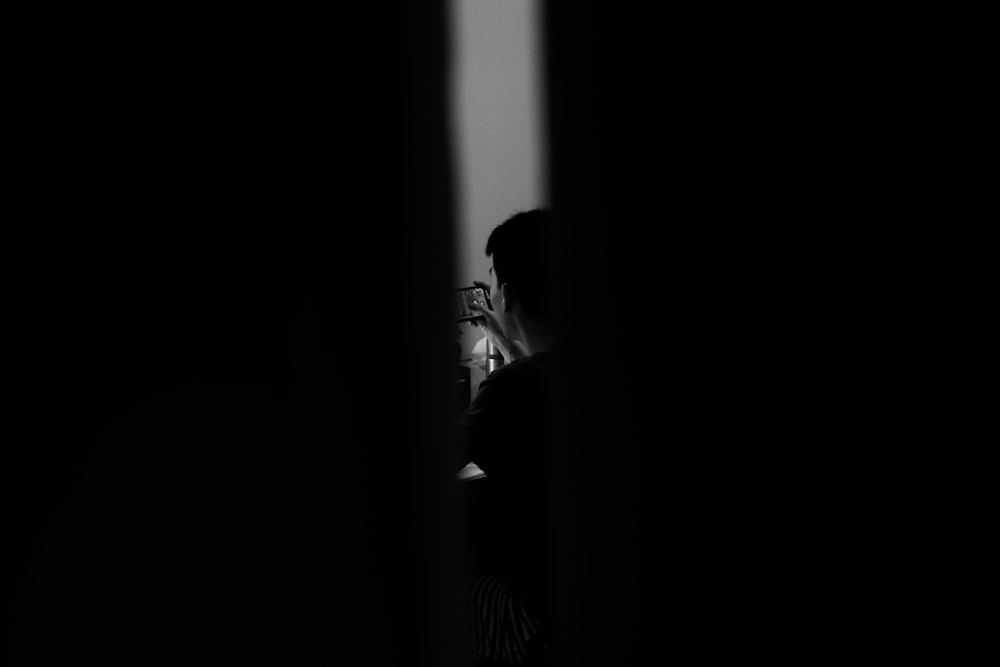 silhouette of woman standing in front of window
