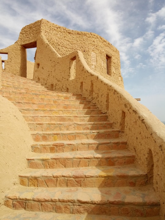 brown concrete stairs under blue sky during daytime in Siwa Egypt