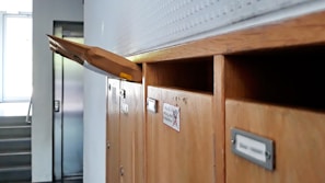 brown wooden cabinet near white window blinds