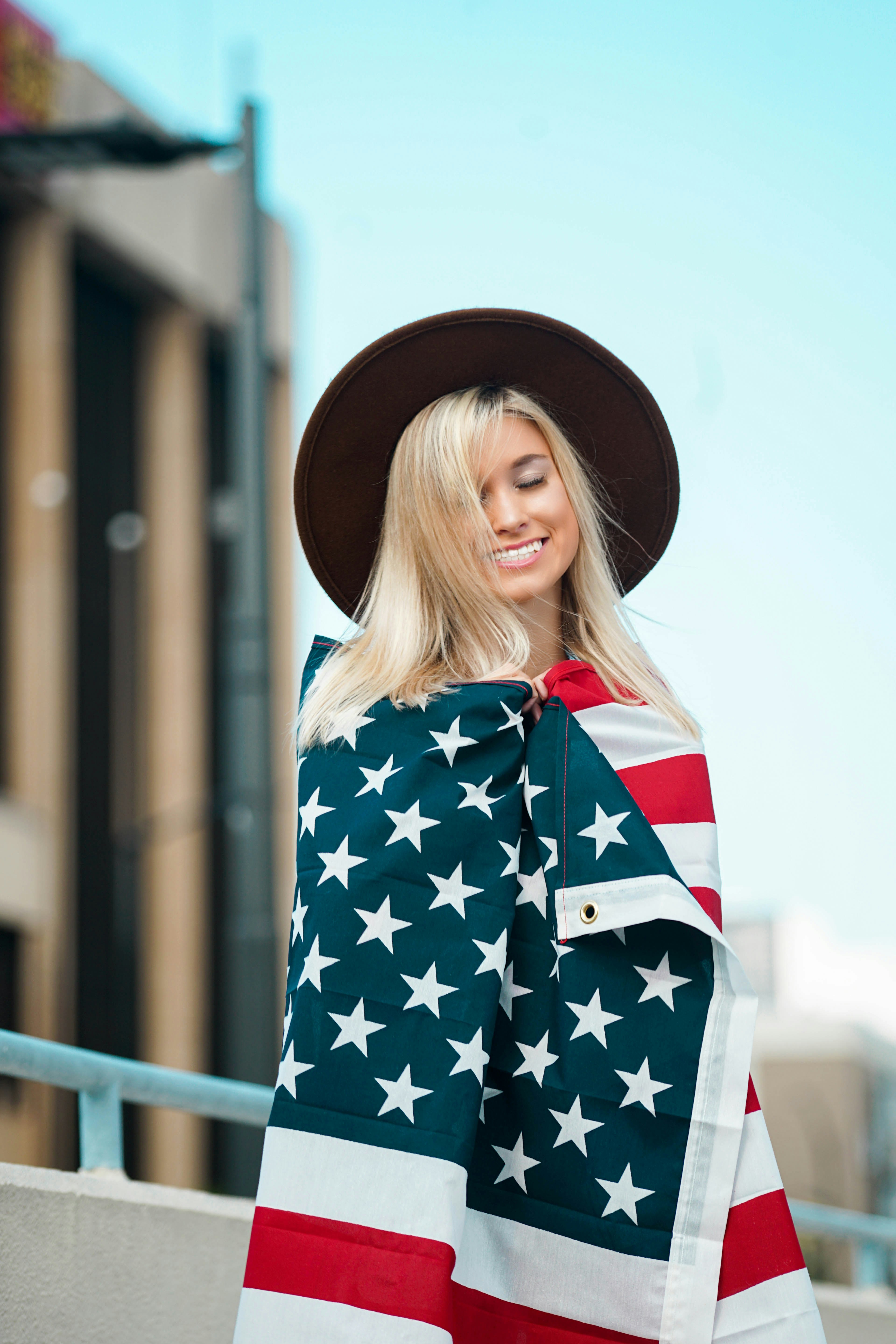 woman in blue and white floral long sleeve shirt wearing brown hat