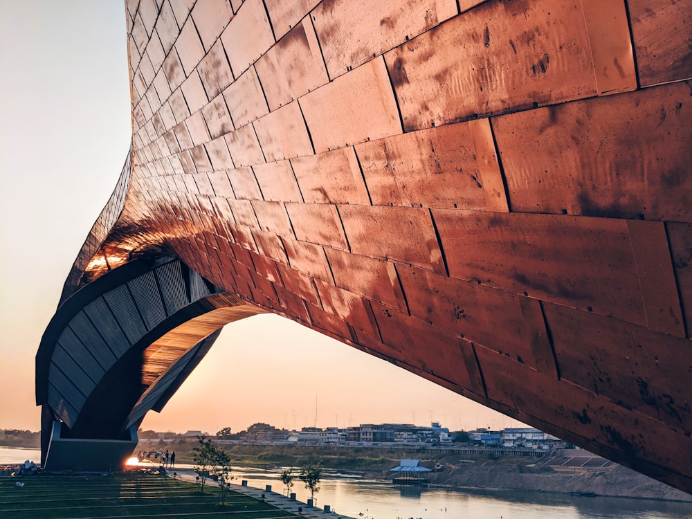 brown wooden wall near body of water during daytime