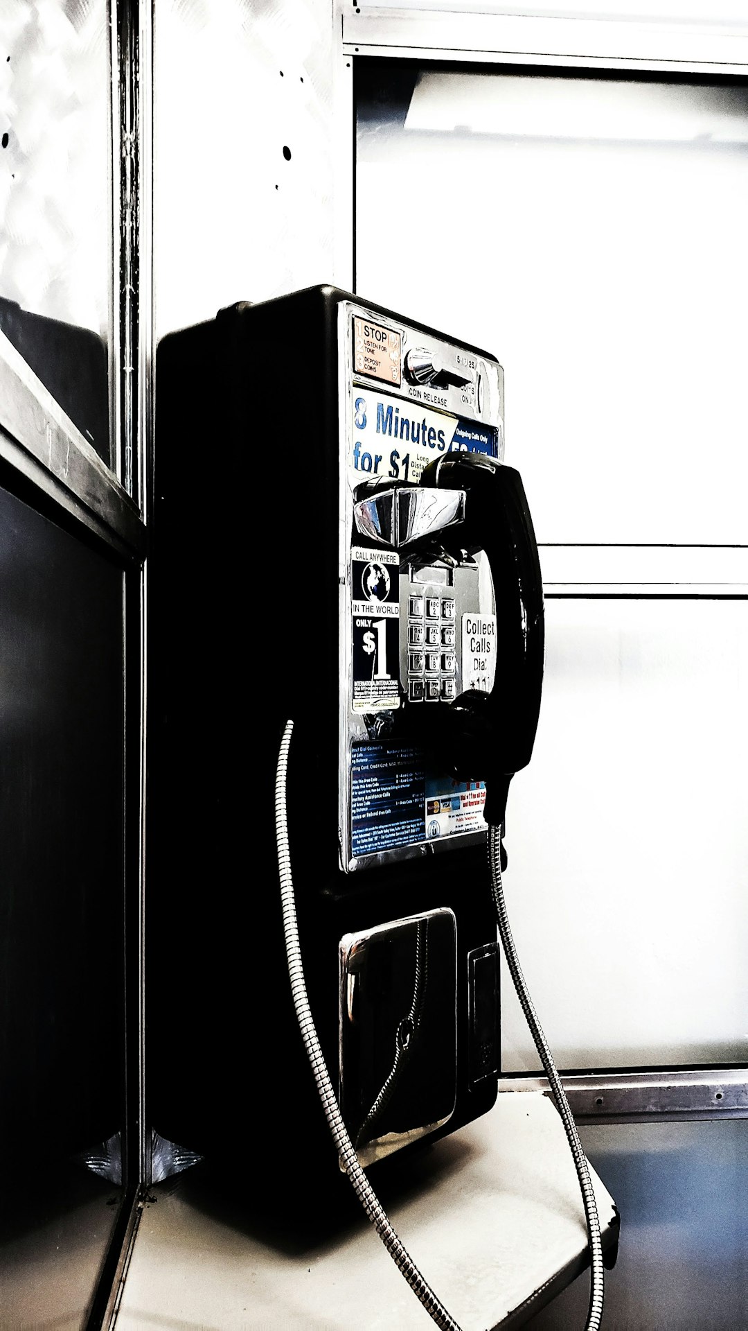 black and silver telephone on black wall mounted telephone