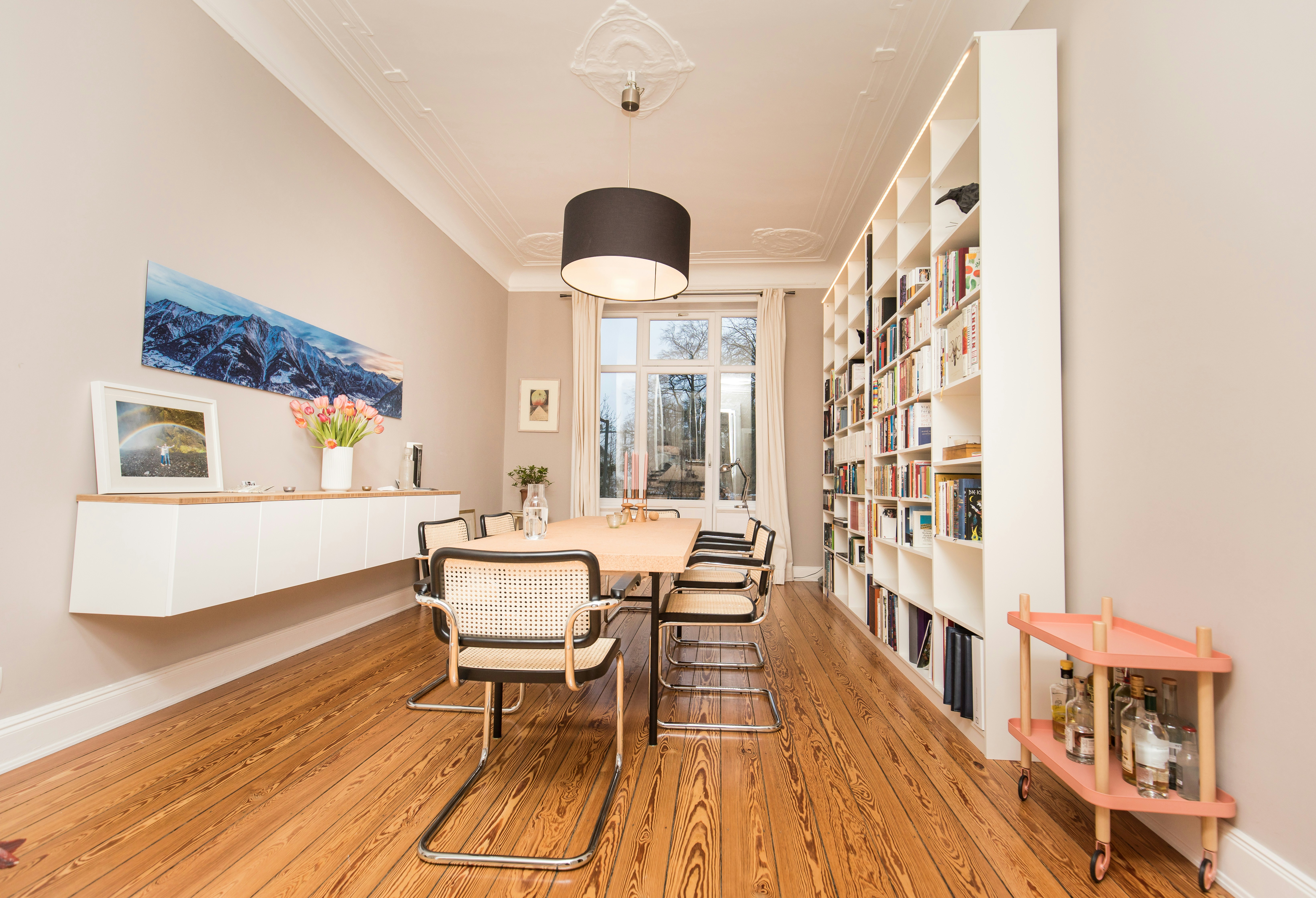 Free-floating sideboard in a combination of MDF and solid wood combined with a custom-made bookcase for a dining room.