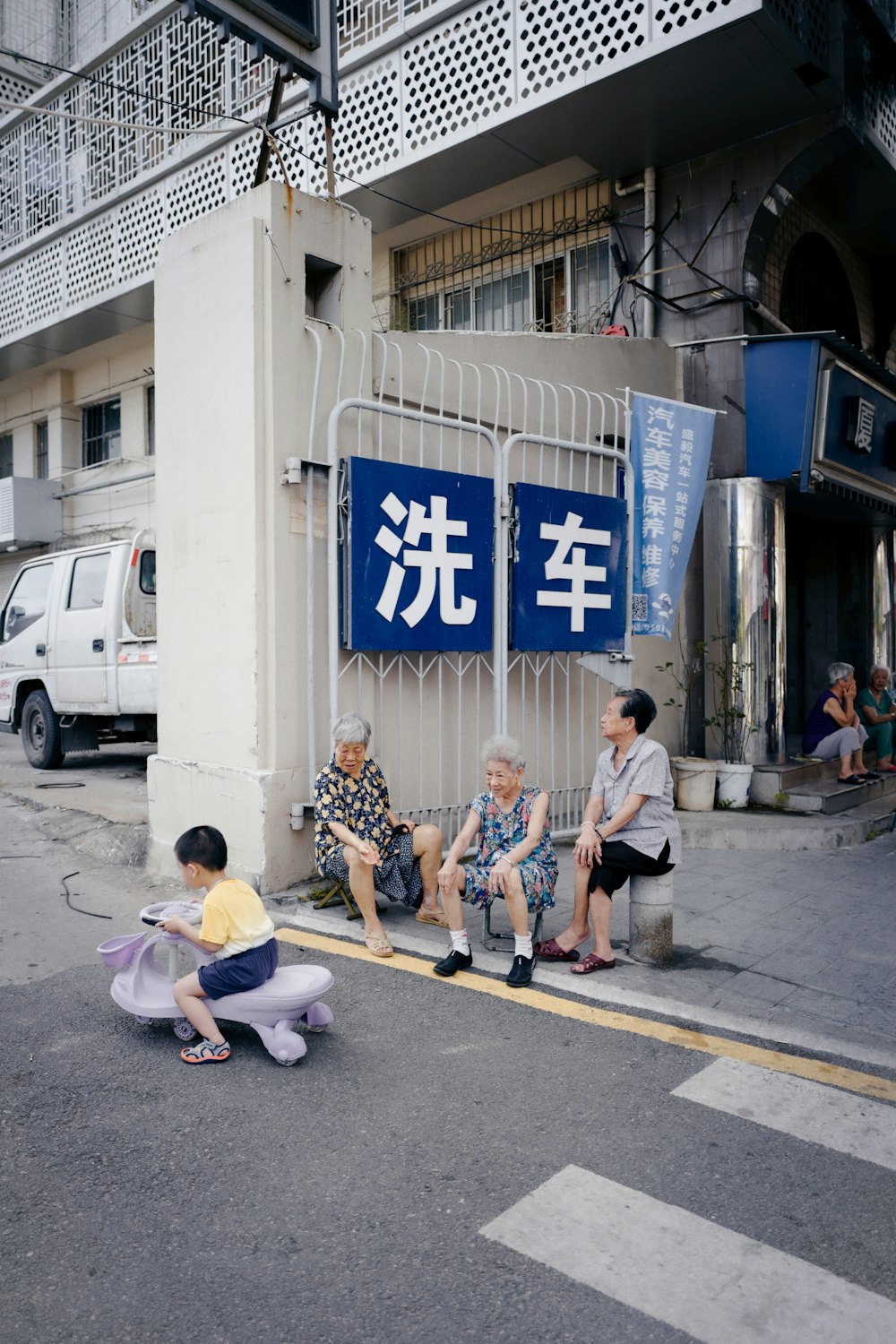 people sitting on sidewalk during daytime