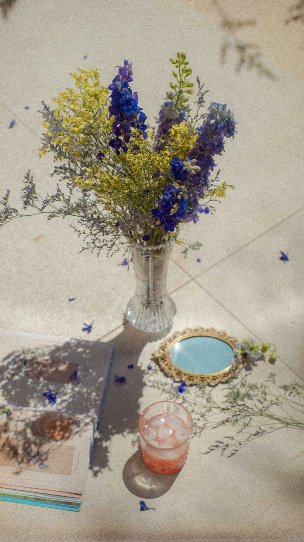 purple flowers in clear glass vase