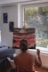 woman in pink tank top standing near window