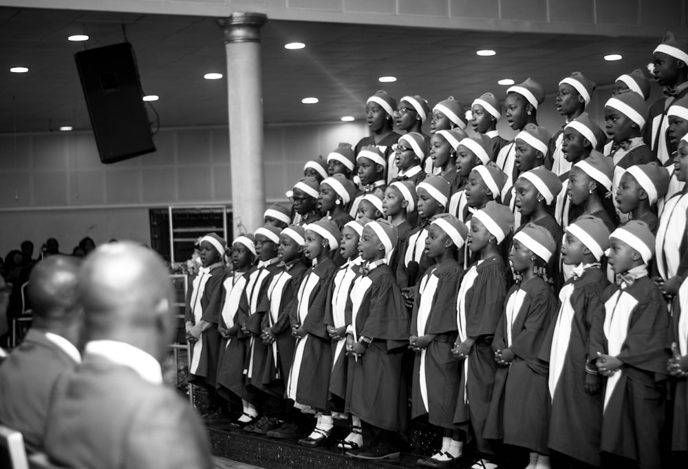 grayscale photo of people in white and black suits