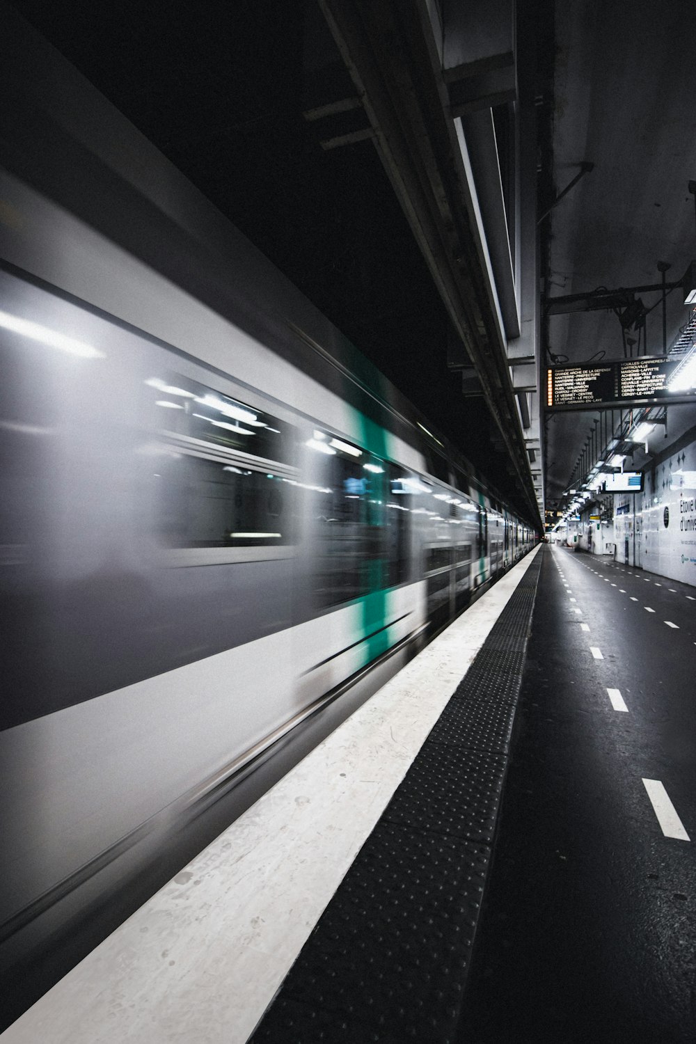 white and green train in train station