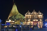 A beautifully decorated Durga Puja mandap illuminated at night.