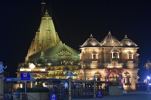 A beautifully decorated Durga Puja mandap illuminated at night.