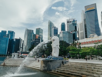 white statue of man on top of gray concrete blocks