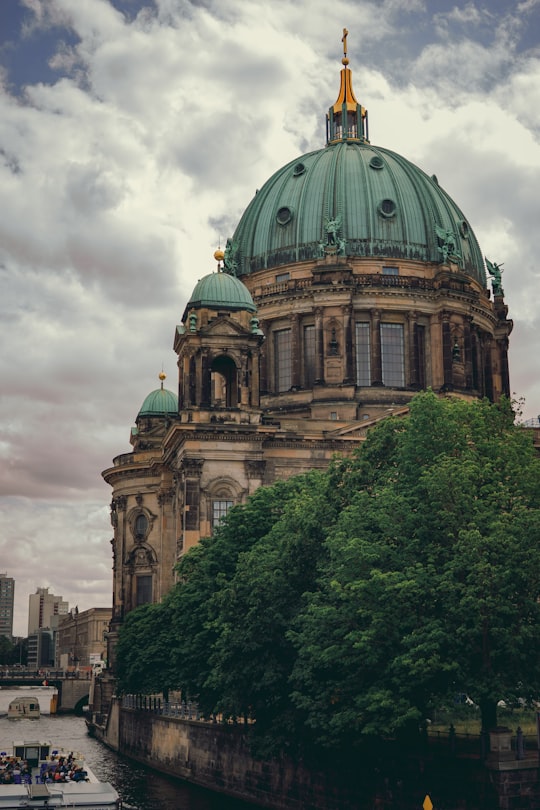 brown and green dome building under white clouds during daytime in Berlin Cathedral Germany