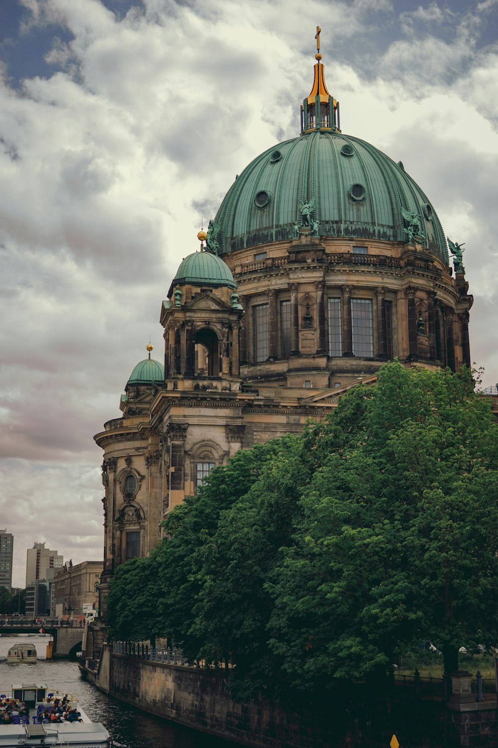 brown and green dome building under white clouds during daytime