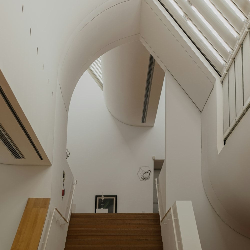 brown wooden staircase on white concrete building