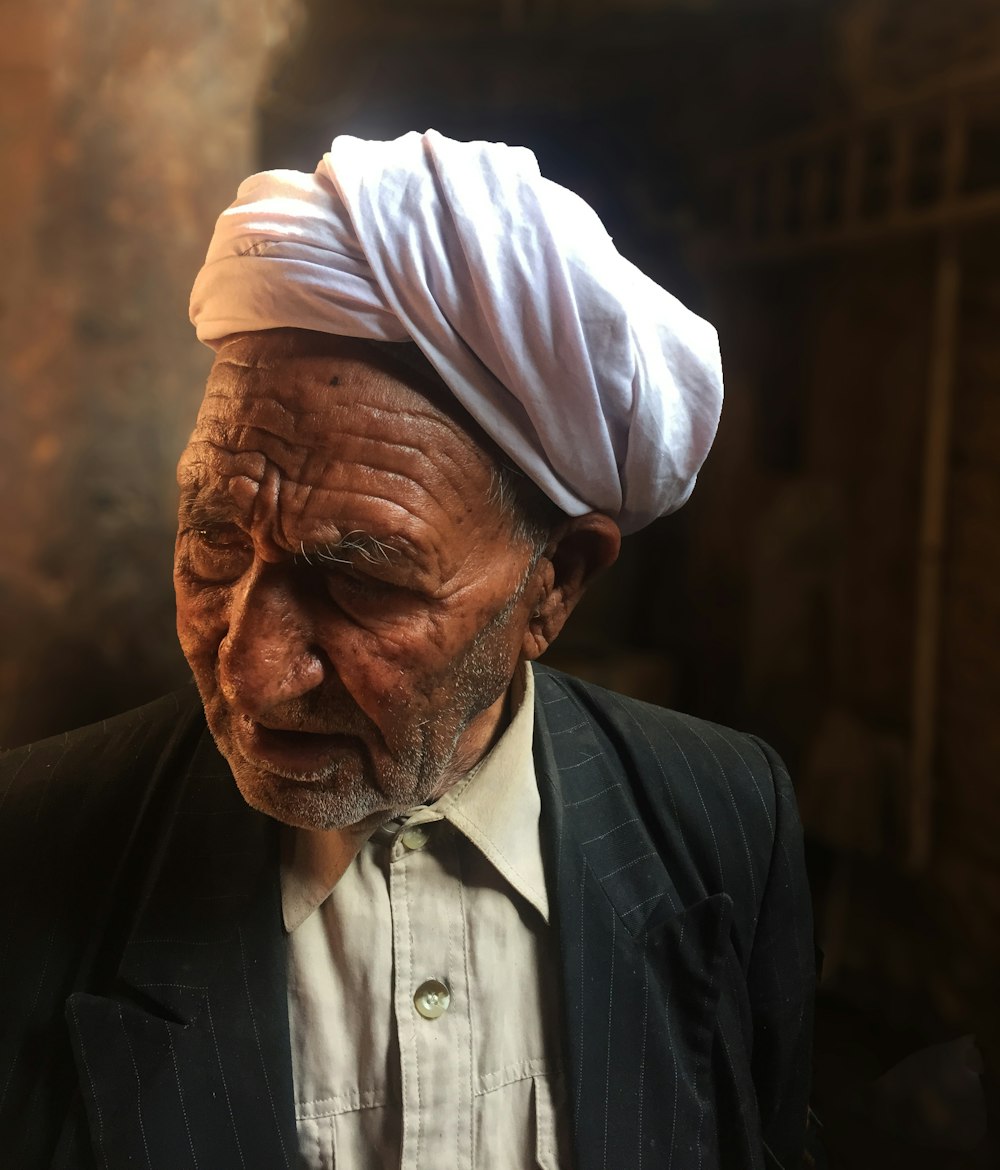 man in black suit jacket wearing white turban